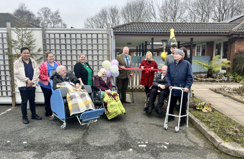 Suzanne Webb MP and Cllr Damian Corfield with Nursing Home residents and staff