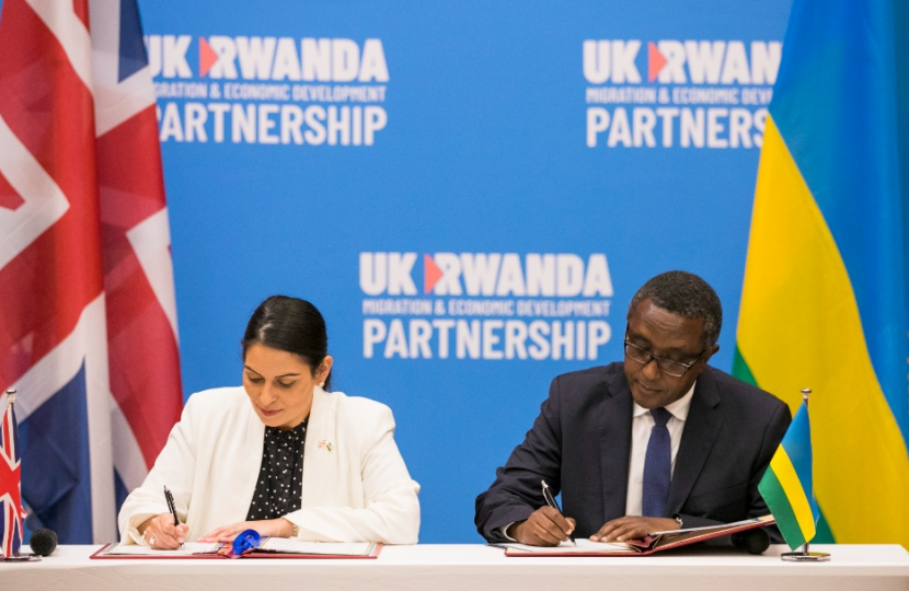 Home Secretary Priti Patel MP signing the agreement with Vincent Biruta, the Rwandan Minister for Foreign Affairs